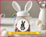 Black silhouette image of an adorable Easter bunny full of springtime charm. The bunny has tall floppy ears, a round chubby body, and a sweet little face that feels friendly and playful. It holds a woven basket packed with colorful Easter eggs, each one softly rounded and cheerful. The bold silhouette is accented with simple details, giving it a cute folk-art look that pops beautifully.